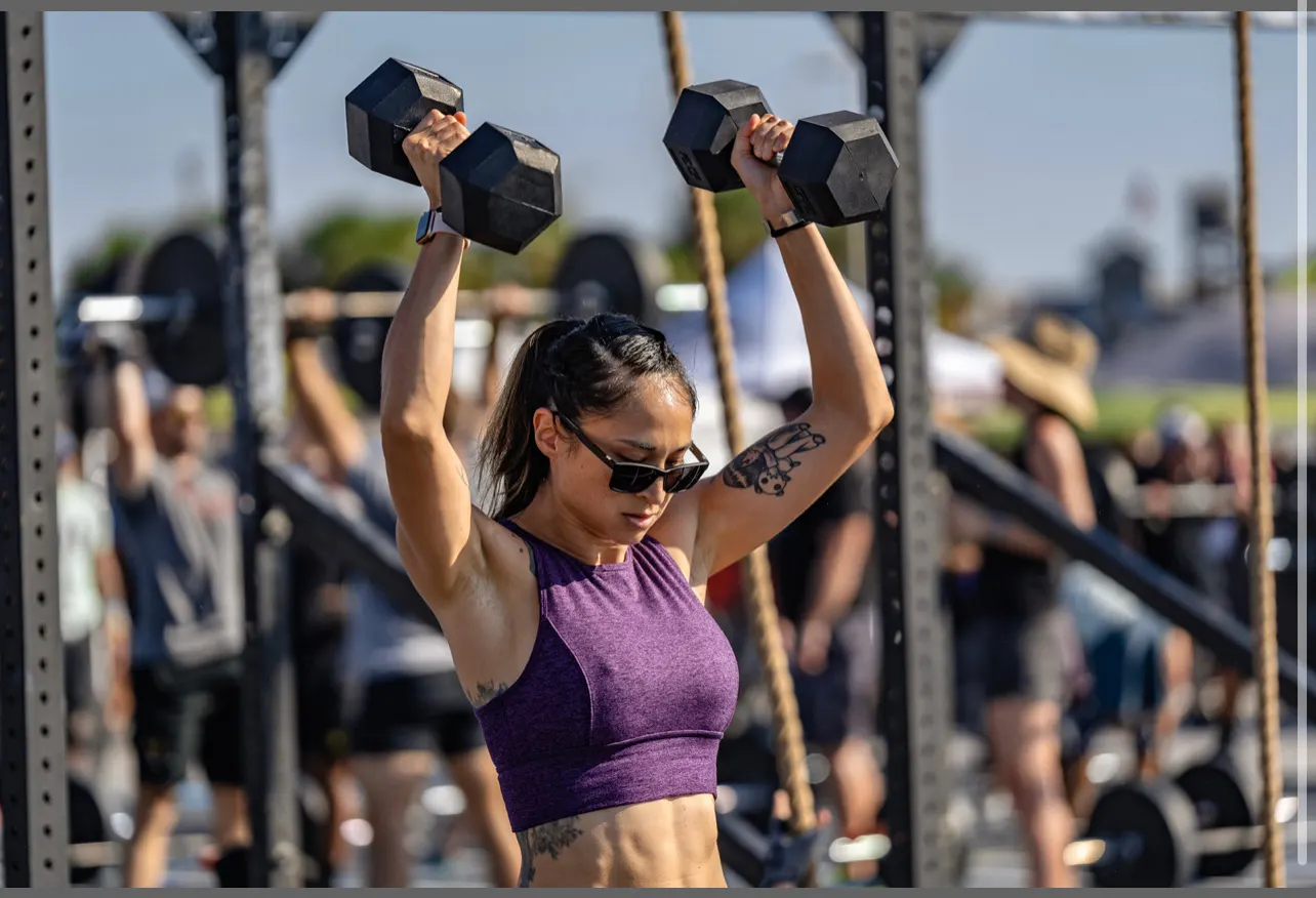 Sara pressing dumbbells overhead